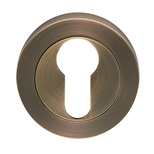 This is an image of a Carlisle Brass - Euro Profile escutcheon - Antique Brass that is availble to order from Trade Door Handles in Kendal.