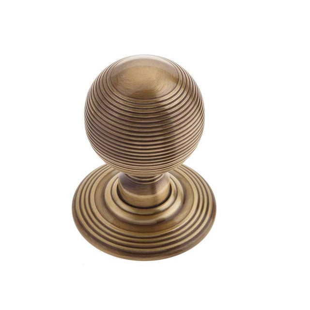 This is an image of a Frelan - Reeded Unsprung Mortice Knobs - Antique Brass  that is availble to order from Trade Door Handles in Kendal.
