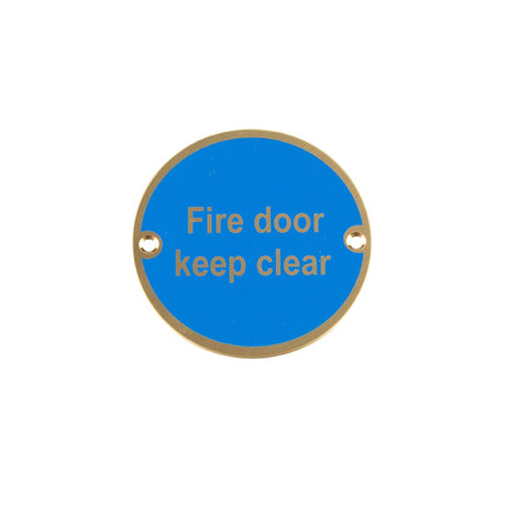 This is an image of a Frelan - Fire Door Keep Clear - Signage 75mm Dia. - Polished Brass that is availble to order from Trade Door Handles in Kendal.