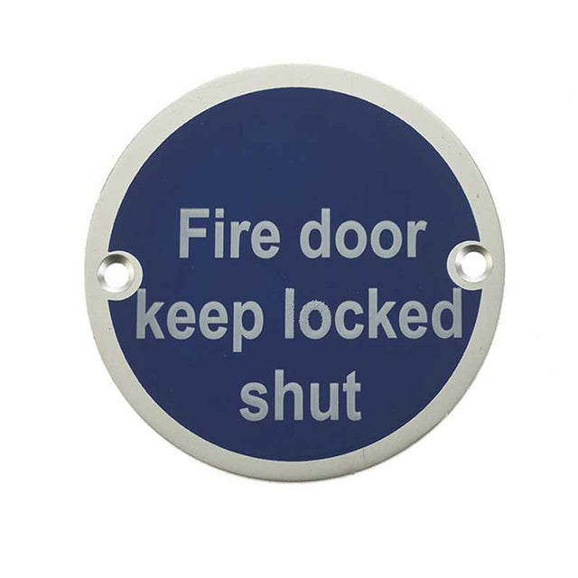 This is an image of a Frelan - Fire Door Keep Locked Shut - Signage 75mm Dia. - Satin Anodised Alumini  that is availble to order from Trade Door Handles in Kendal.