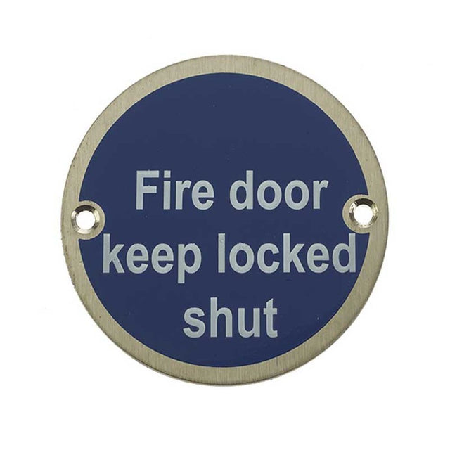 This is an image of a Frelan - Fire Door Keep Locked Shut - Signage 75mm Dia. - Satin Stainless Steel that is availble to order from Trade Door Handles in Kendal.