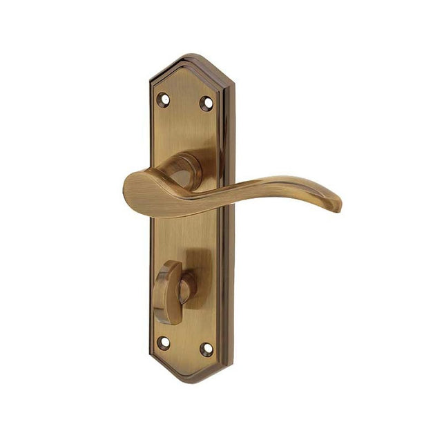 This is an image of a Frelan - Paris Bathroom Lock Handles on Backplates - Antique Brass  that is availble to order from Trade Door Handles in Kendal.