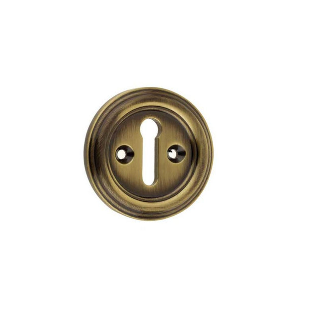 This is an image of a Frelan - Parisian Standard Key Escutcheon - Antique Brass  that is availble to order from Trade Door Handles in Kendal.