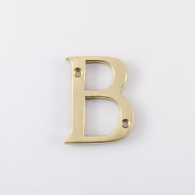 This is an image of a Carlisle Brass - Letter B - Polished Brass that is availble to order from Trade Door Handles in Kendal.