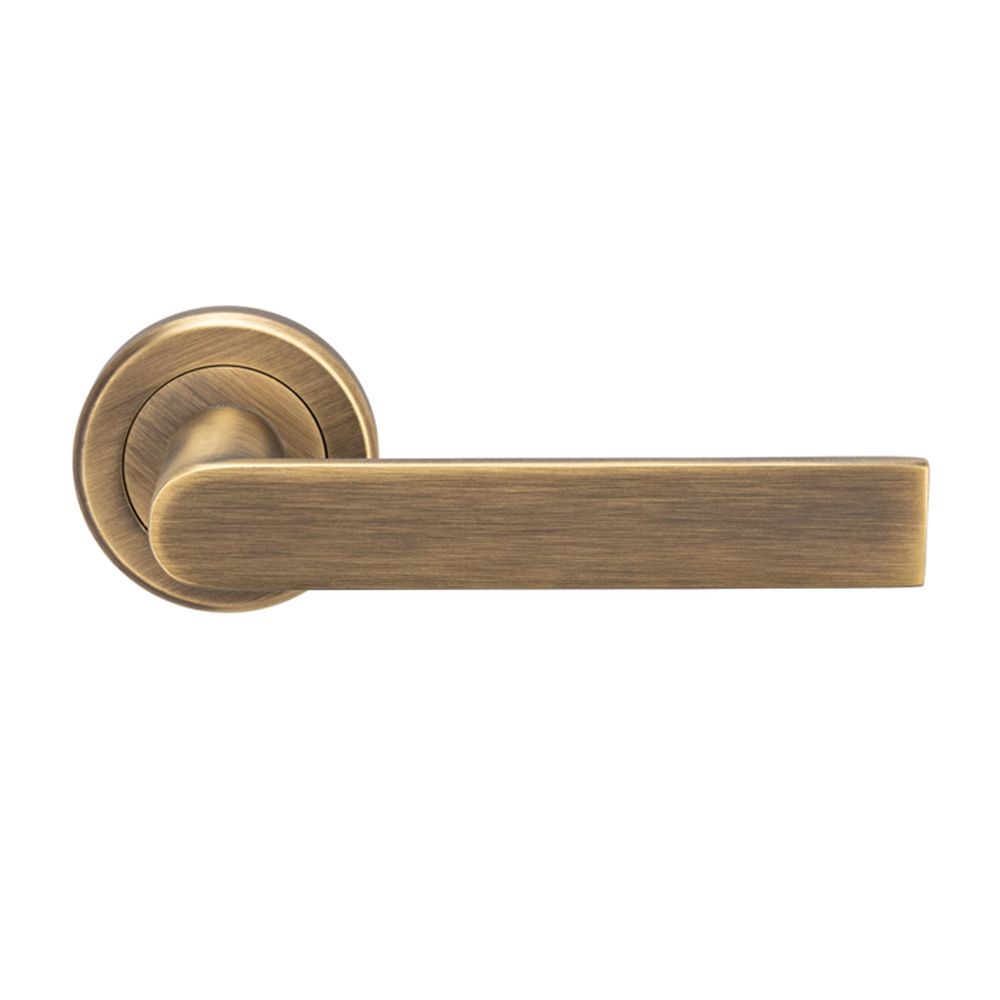 This is an image of a Serozzetta - Edge Lever on Round Rose - Antique Brass that is availble to order from Trade Door Handles in Kendal.