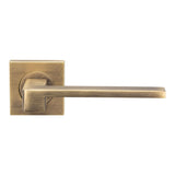 This is an image of a Serozzetta - Equi Lever on Square Rose - Antique Brass that is availble to order from Trade Door Handles in Kendal.