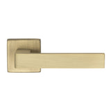 This is an image of a Manital - Techna Lever on Square Rose Antique Brass - Antique Brass that is availble to order from Trade Door Handles in Kendal.